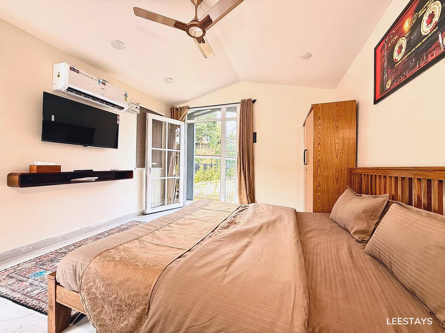 Bedroom with a bed, television, air conditioner, and closet.