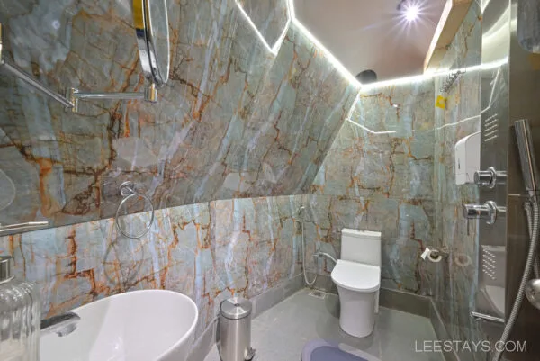 Luxurious bathroom at Dome Story Resort, Malvandi Lake, featuring sleek marble walls and modern fixtures.